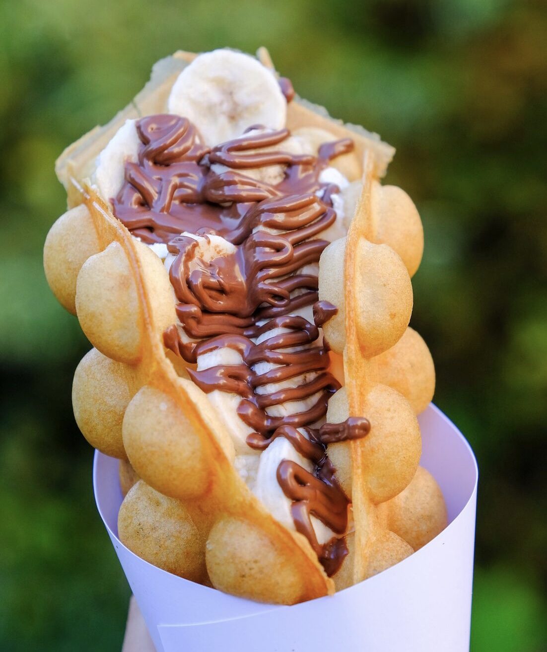 A bubble waffle with banana and chocolate sauce